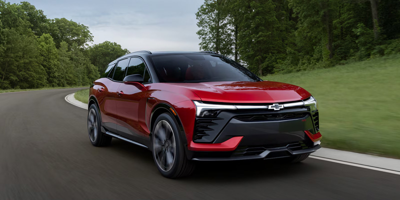 2026 Blazer EV driving on a road in North Richland Hills, TX, showcasing its sleek design and electric capabilities.
