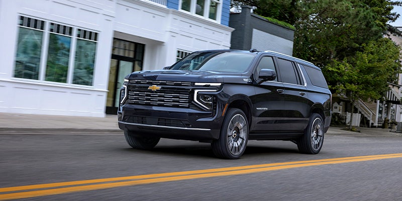 Chevrolet Suburban driving down the road