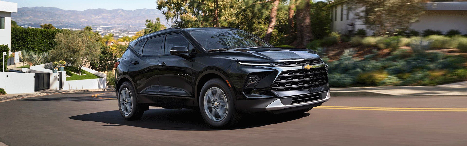 2026 Chevrolet Blazer driving through scenic road.